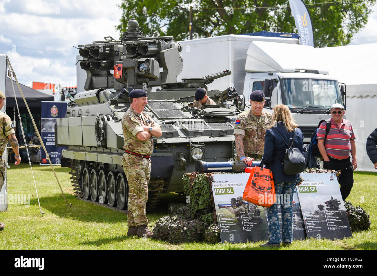 Ardingly Sussex UK 6th June 2019 - The army stand enjoy the sunshine on the first day of the South of England Show held at the Ardingly Showground in Sussex. The annual agricultural show highlights the best in British farming and produce and attracts thousands of visitors over three days . Credit : Simon Dack / Alamy Live News Stock Photo