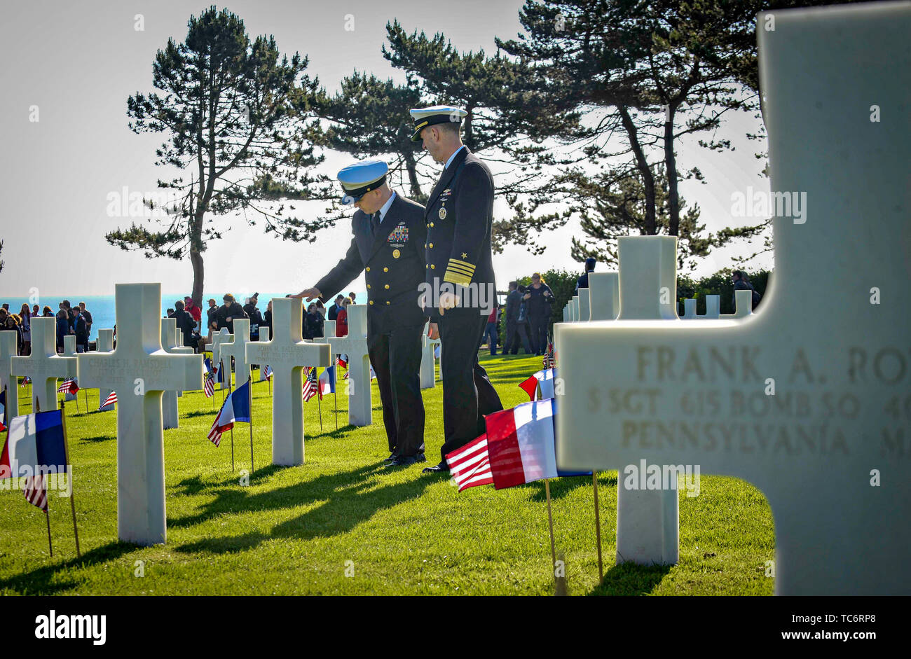 Pointe Du Hoc, France. 06th June, 2019. U.S. Nay Master Chief Petty Officer of the Navy Russell Smith, left, and Chief of Naval Operations Adm. John Richardson visit the Normandy American Cemetery on the anniversary of the D-Day invasion June 6, 2019 in Pointe du Hoc, Normandy, France. Thousands have converged on Normandy to commemorate the 75th anniversary of Operation Overlord, the WWII Allied invasion commonly known as D-Day. Credit: Planetpix/Alamy Live News Stock Photo