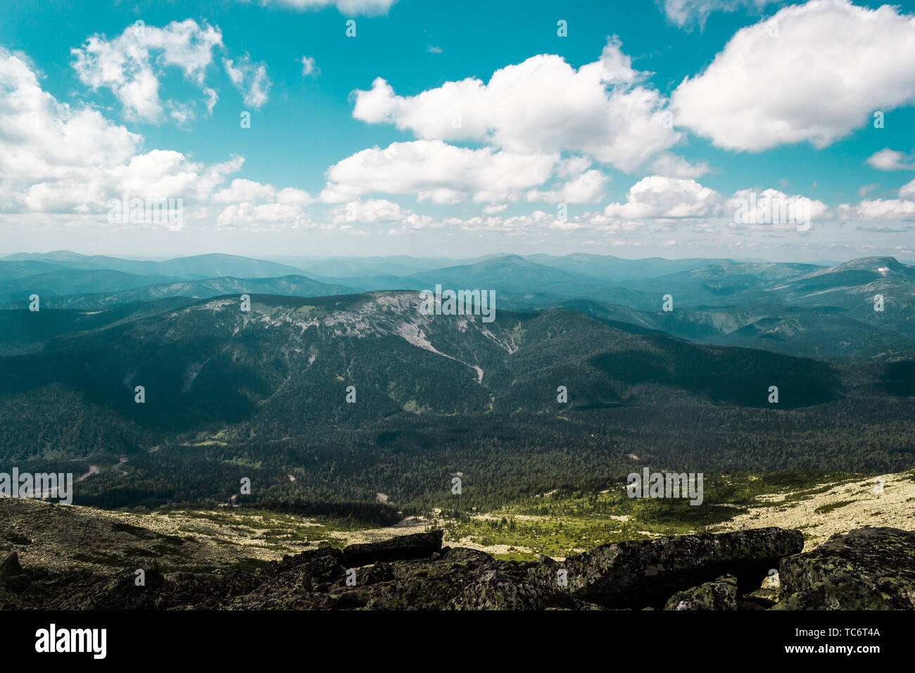 Rocks under blue sky with clouds. View of mountain valley. Tourism ...