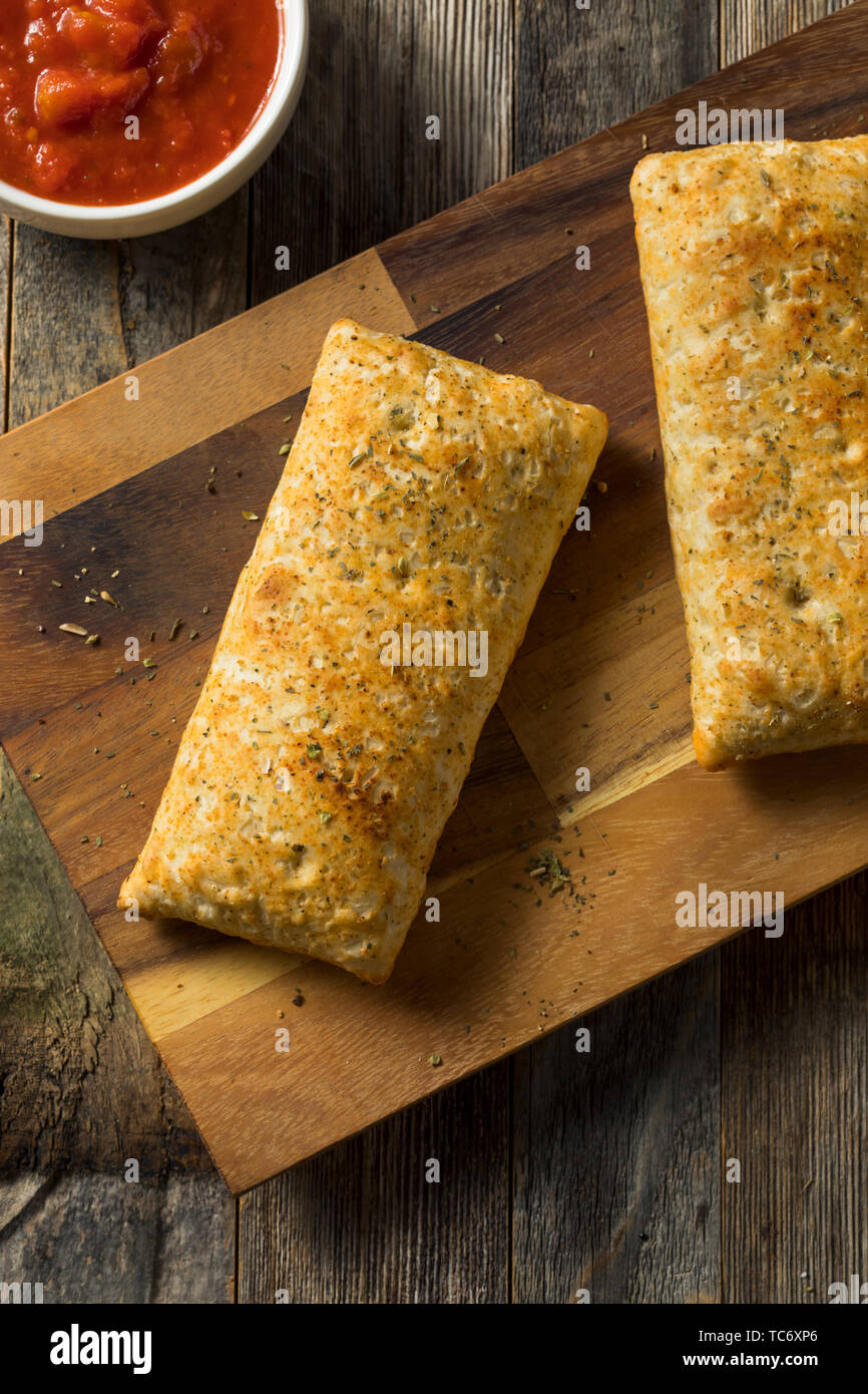 Unhealthy Microwaved Pizza Pockets with Cheese and Sauce Stock Photo