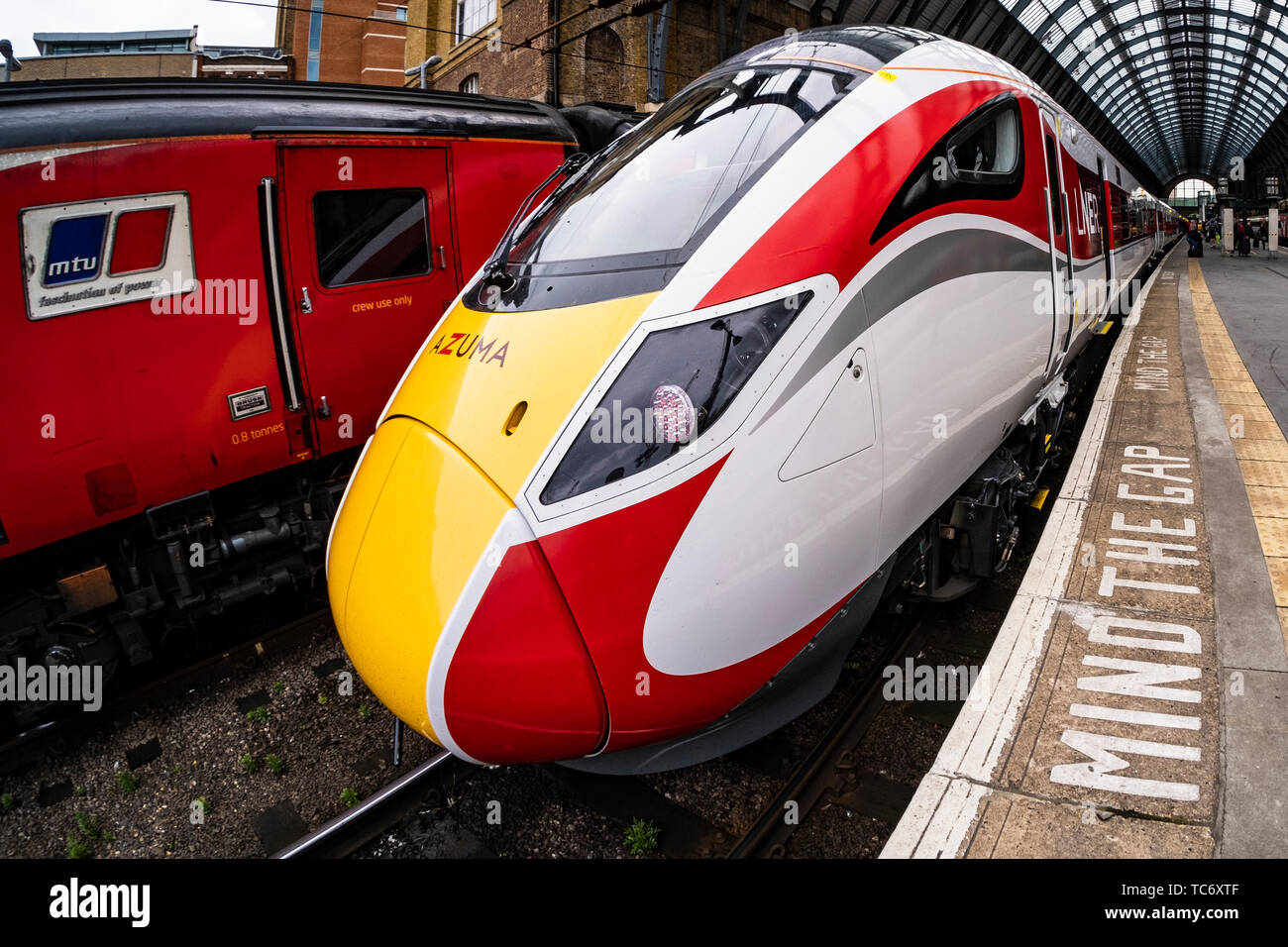 A New LNER Azuma train sits alongside an old diesel HST train at London Kings Cross Station, UK Stock Photo