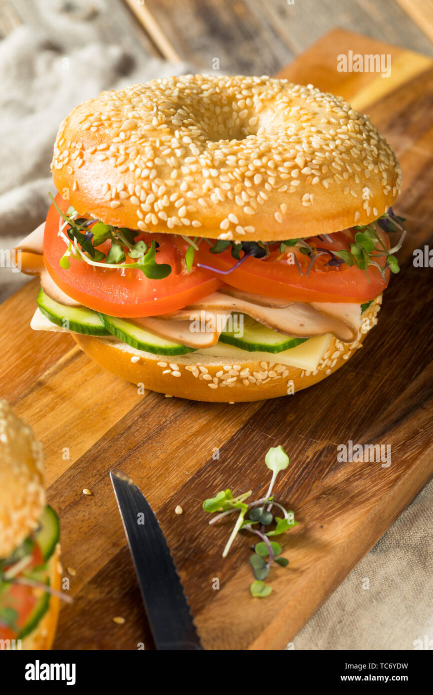 Homemade Bagel Turkey Sandwich with Tomato and Cucumber Stock Photo