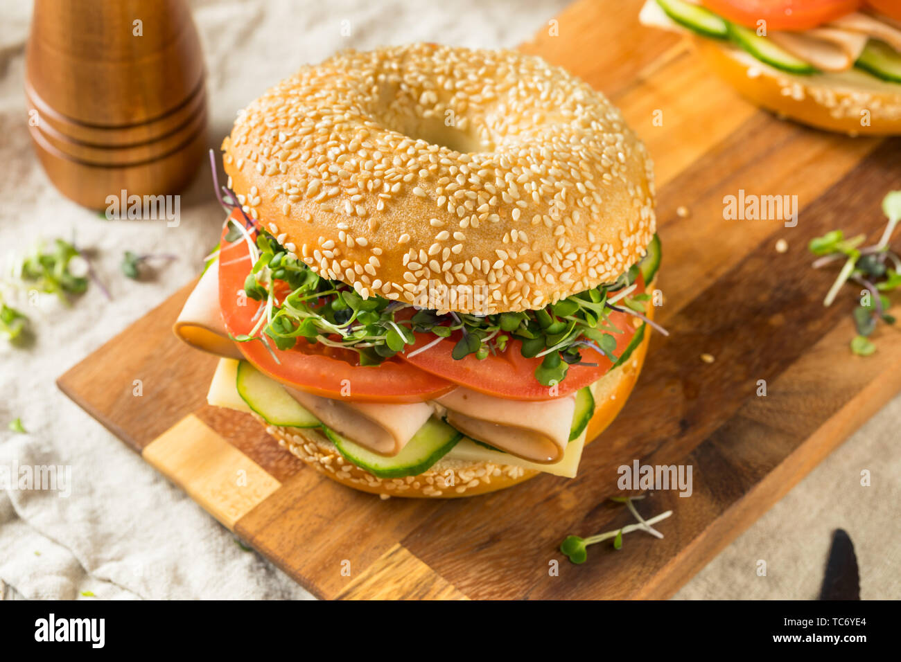 Homemade Bagel Turkey Sandwich with Tomato and Cucumber Stock Photo