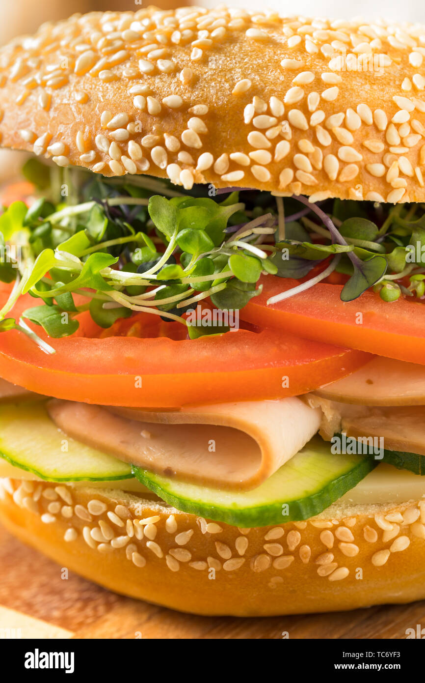 Homemade Bagel Turkey Sandwich with Tomato and Cucumber Stock Photo