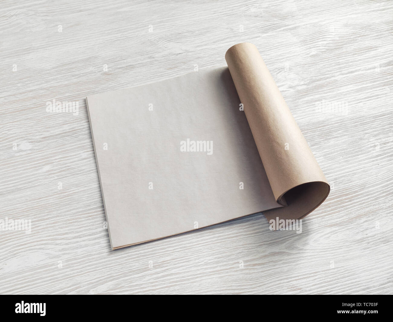 Bank square brochure or magazine on light wooden background. Responsive design mockup. Stock Photo