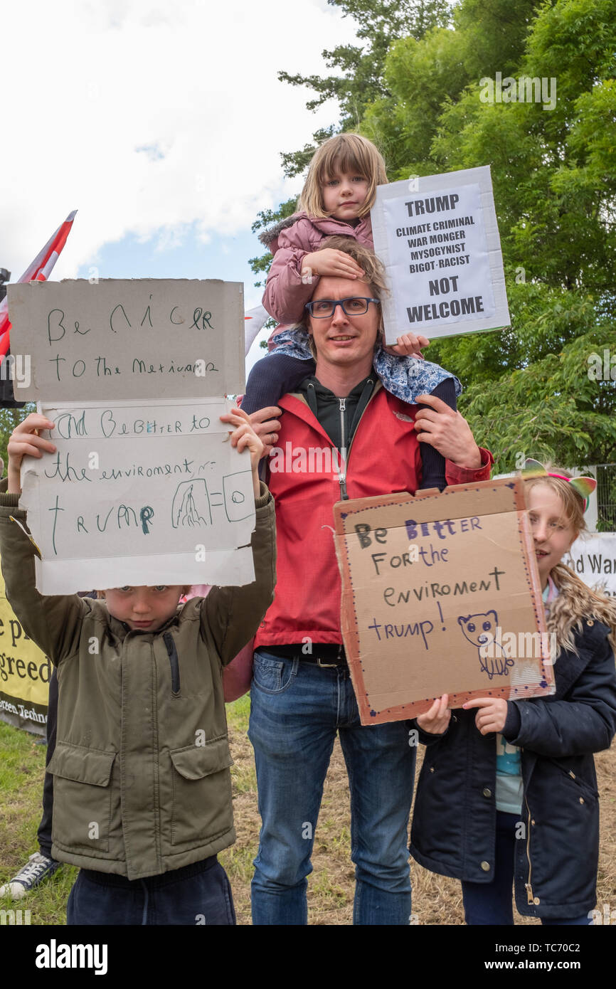 Shannon, Ireland, June. 5, 2019: A father with his young children with signs protesting against the Donald Trump visit with signs at Shannon Airport, Ireland today Stock Photo