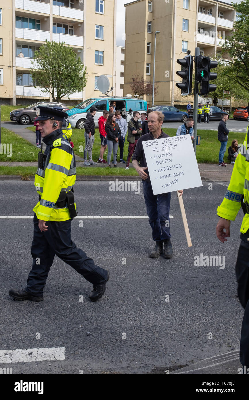 Shannon, Ireland, June. 5, 2019:  Anti Trump protestor with sign crossing road  at Shannon Airport, Ireland today Stock Photo