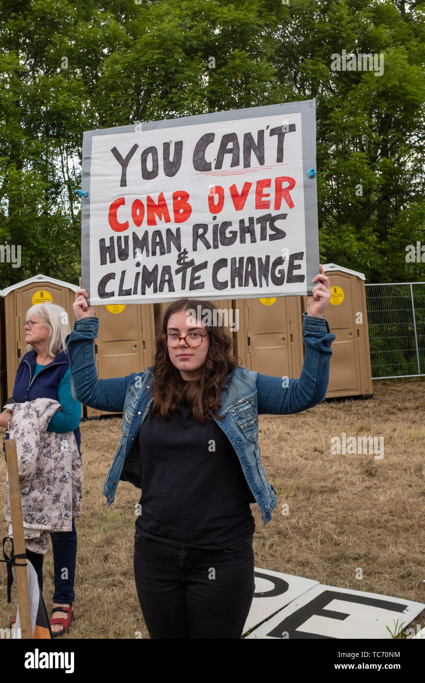 Shannon, Ireland, June. 5, 2019: A young lady protesting against the Donald Trump visit with signs at Shannon Airport, Ireland at Shannon Airport, Ireland Stock Photo