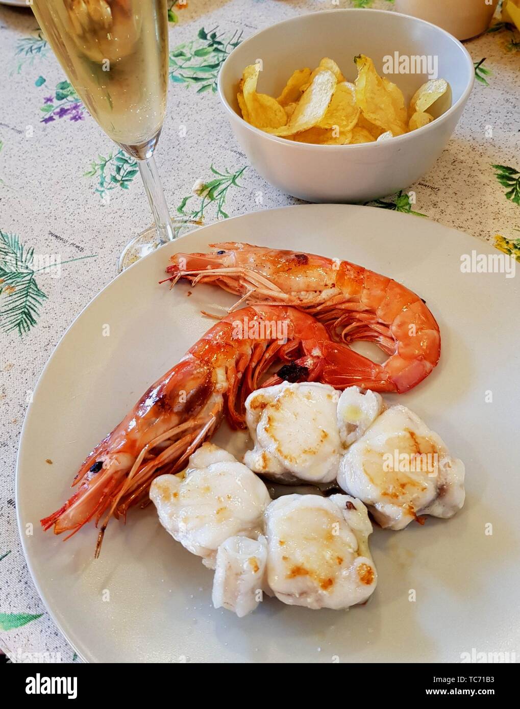 Food. Spanish. Grilled prawns, monk fish and potato chips. Catalan culinary delicacy. Barcelona. El Maresme, Catalunya. Spain Stock Photo