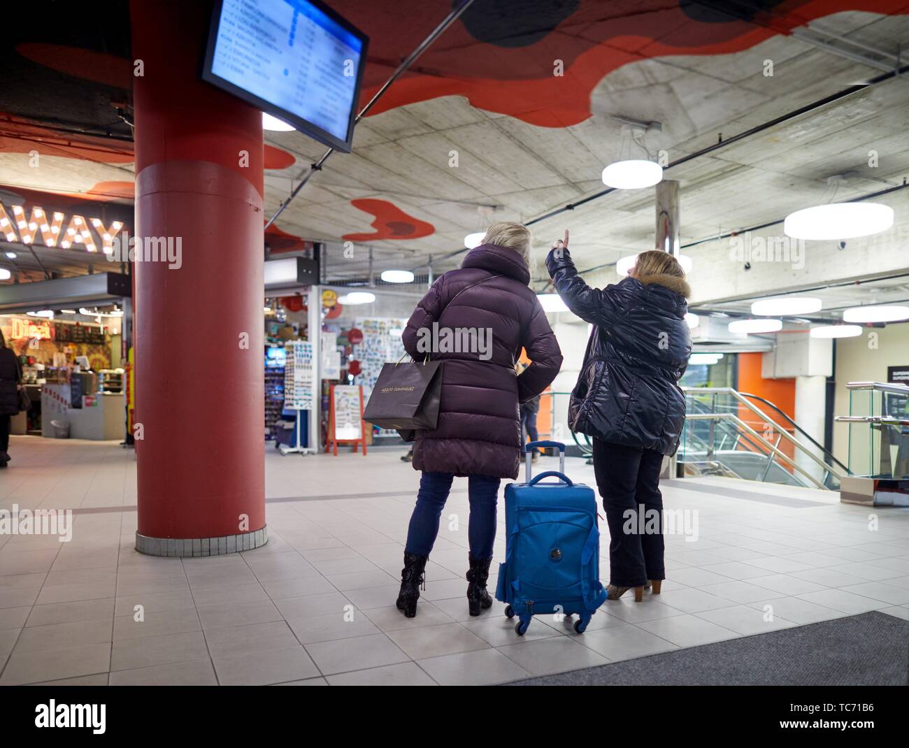 Women looking at the timetable screen, Bus station, Donostia, San Sebastian, Gipuzkoa, Basque Country, Spain, Europe Stock Photo