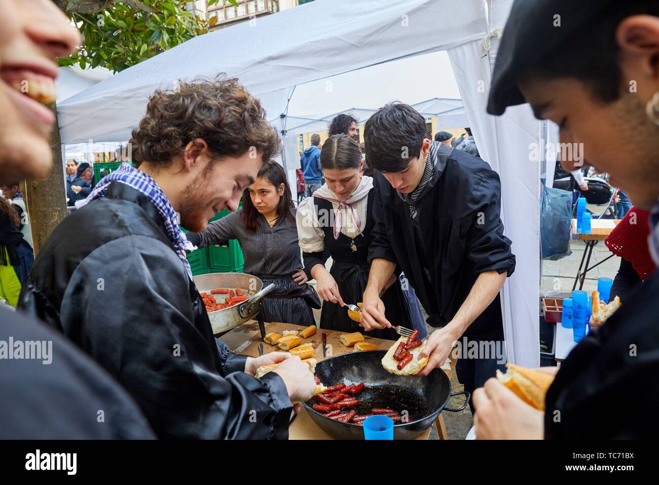 Frying txistorra (chorizo), People dressed in typical baserritarra clothes, Fair of Santo Tomas, Donostia, San Sebastian, Gipuzkoa, Basque Country, Stock Photo