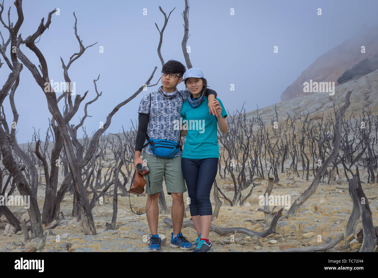 A young korean couple are doing outdoor activities on mountain. Papandayan Mountain is one of the favorite place to hike on Garut Stock Photo