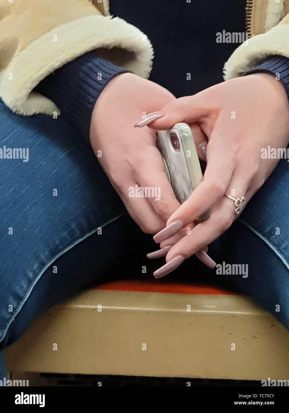 Woman Hands With Long Artificial Nails Holding A Phone New