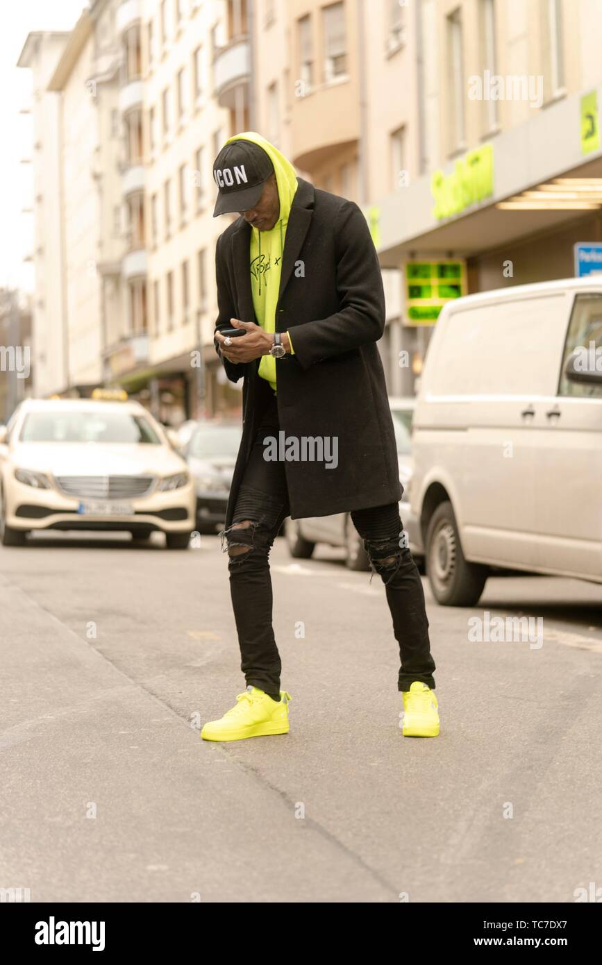 streetstyle, stylish man with smartphone walking at street in city