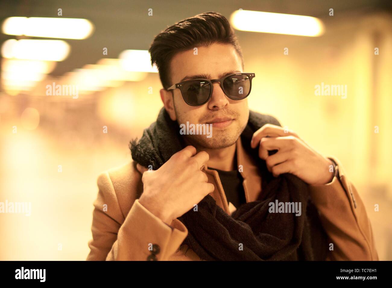Young Fashionable Man With Scarf And Sunglasses Indoors In