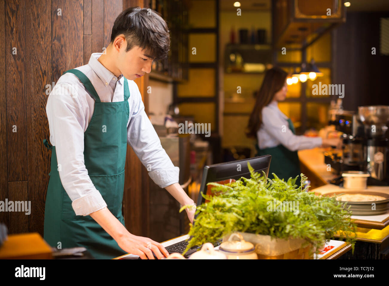 Make Waiters Make it waitress and waiter in cafe Stock Photo - Alamy