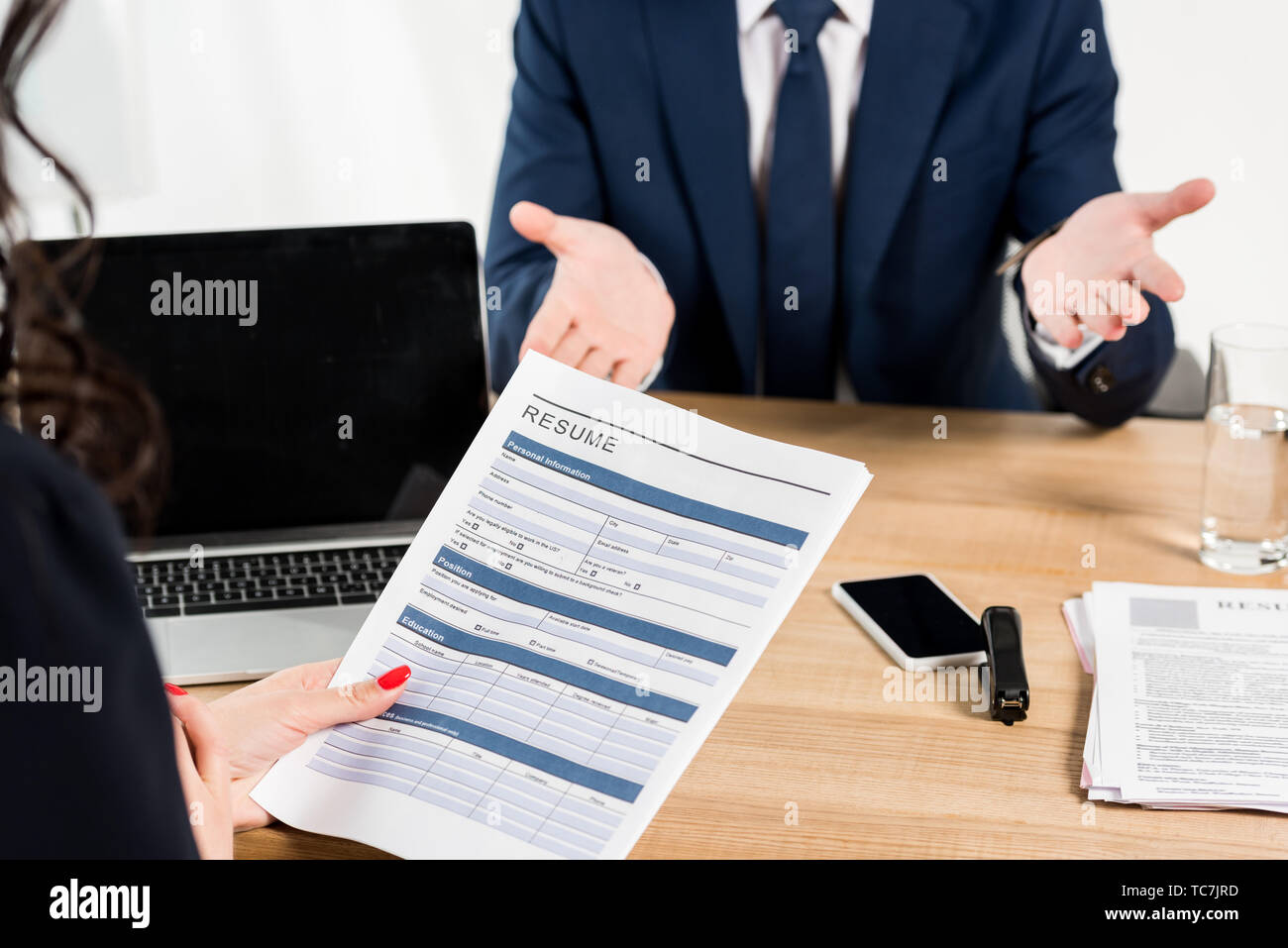 cropped view of recruiter holding - Cropped View Of Recruiter Holding Resume Near Man Gesturing In Office TC7JRD 