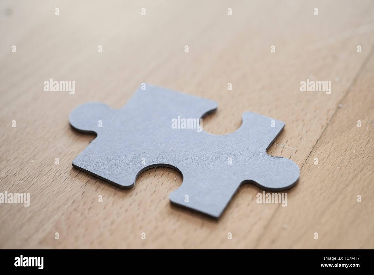 Puzzle piece on wood background Stock Photo - Alamy