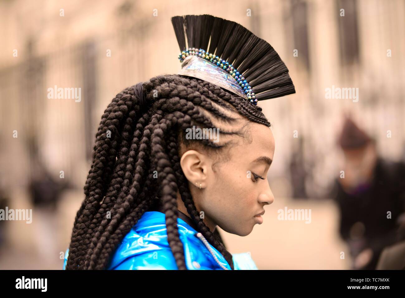 Street Style - Paris Fashion Week Womenswear Fall/Winter 2019/2020, guest with hair decoration, dreadlock hair style, metallic blue jacket, seen Stock Photo
