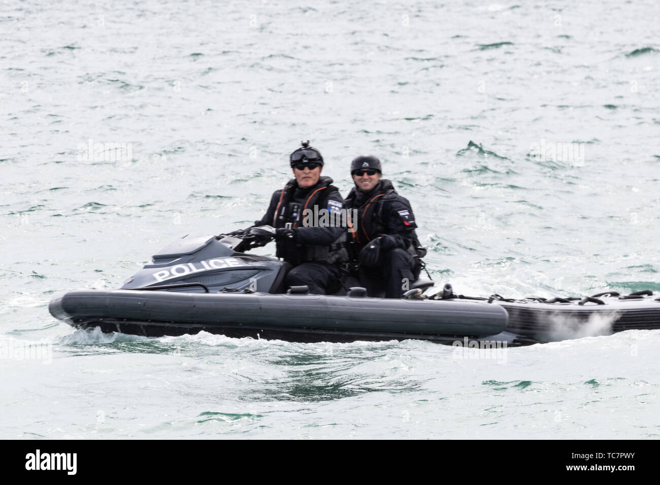 Two British police officer patrolling the waters around Portsmouth on a jet ski while Donald trump visits for the d-day 75 com Stock Photo