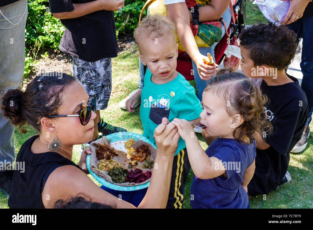 Miami Beach Florida,North Beach,Soul Vegan Festival,food,mother mom,daughter,son,toddler toddlers,feeding tasting eating,mixed race ethnicity,visitors Stock Photo