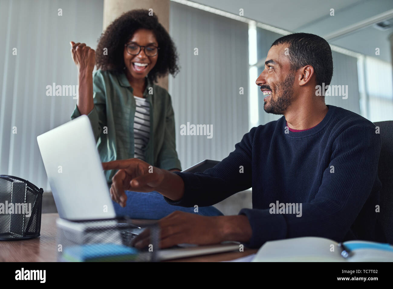Cheerful young businesswoman celebrating their success Stock Photo