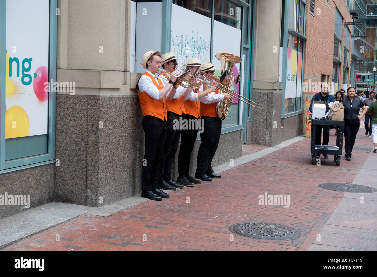 Group of musicians playing horns on sidewalk of Washington Street in downtown Boston Stock Photo