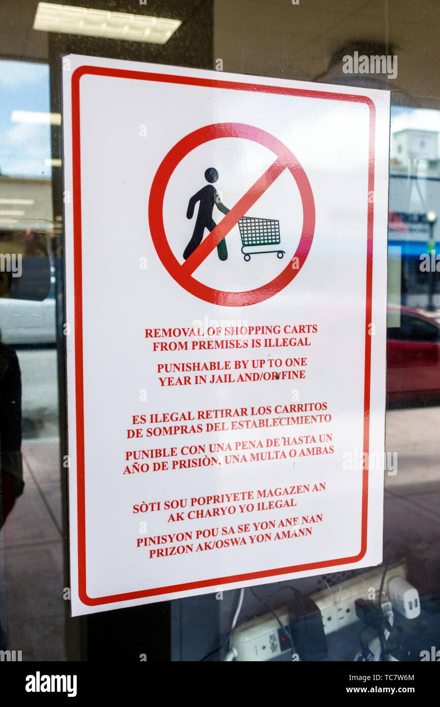 Miami Beach Florida,North Beach,sign warning,shopping cart trolley removal illegal,multiple languages English Spanish Creole,FL190430025 Stock Photo