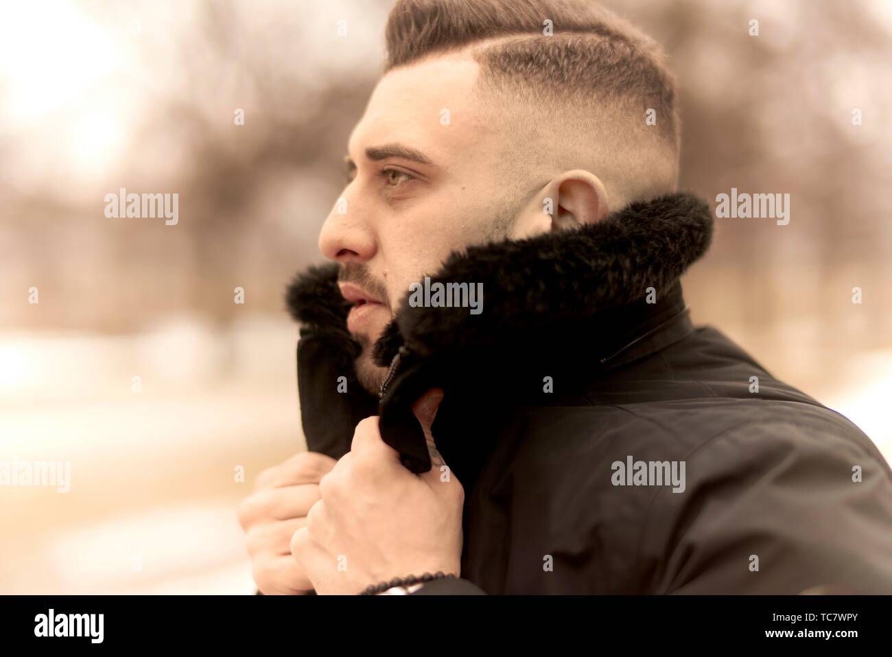 side view of man in winter jacket, Greek ethnicity, in Munich, Germany  Stock Photo - Alamy