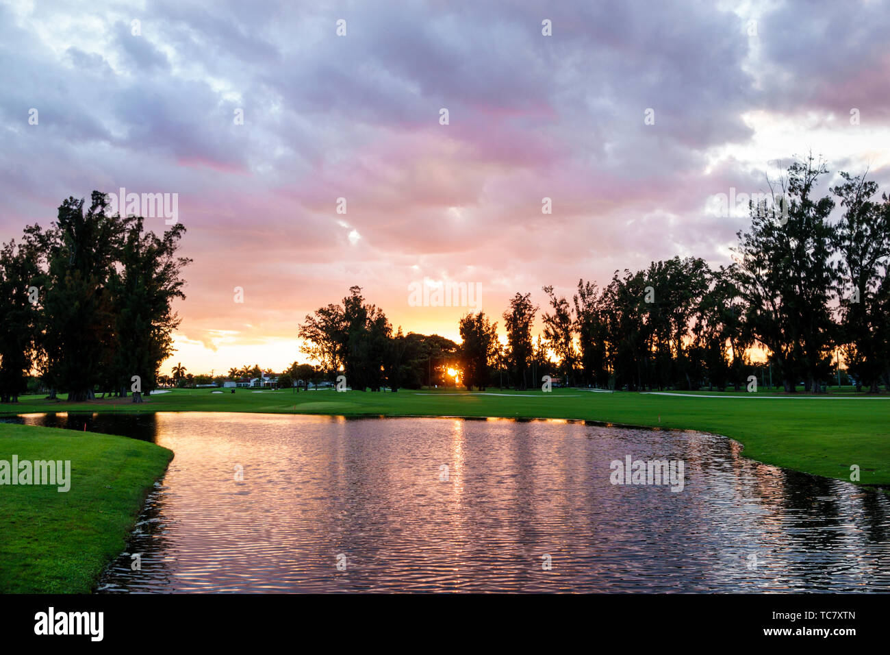 Miami Beach Florida,Normandy Shores Public Golf Club Course,pond water sunset,FL190430056 Stock Photo