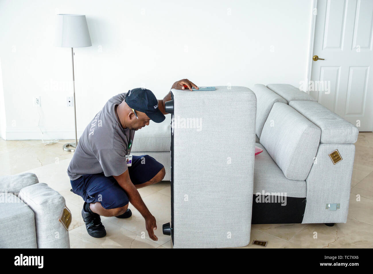 Miami Beach Florida,North Beach,West Elm furniture delivery,Black man men male,unpacking,assembling putting together sofa,FL190430064 Stock Photo
