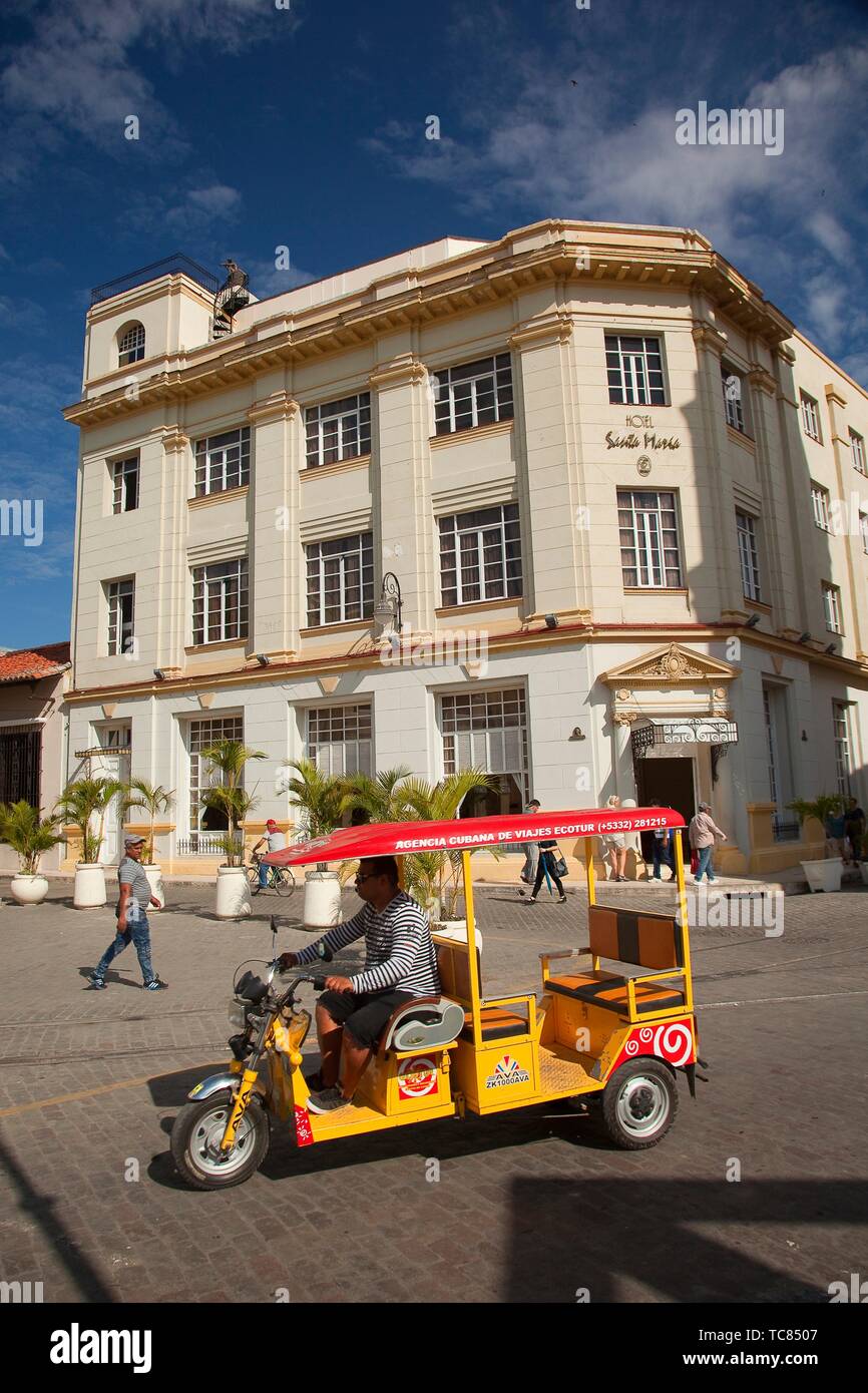 Bici Taxi in front of the colonial building used as Hotel Santa Maria at the historic center, CamagŸey, Cuba, Central America Stock Photo