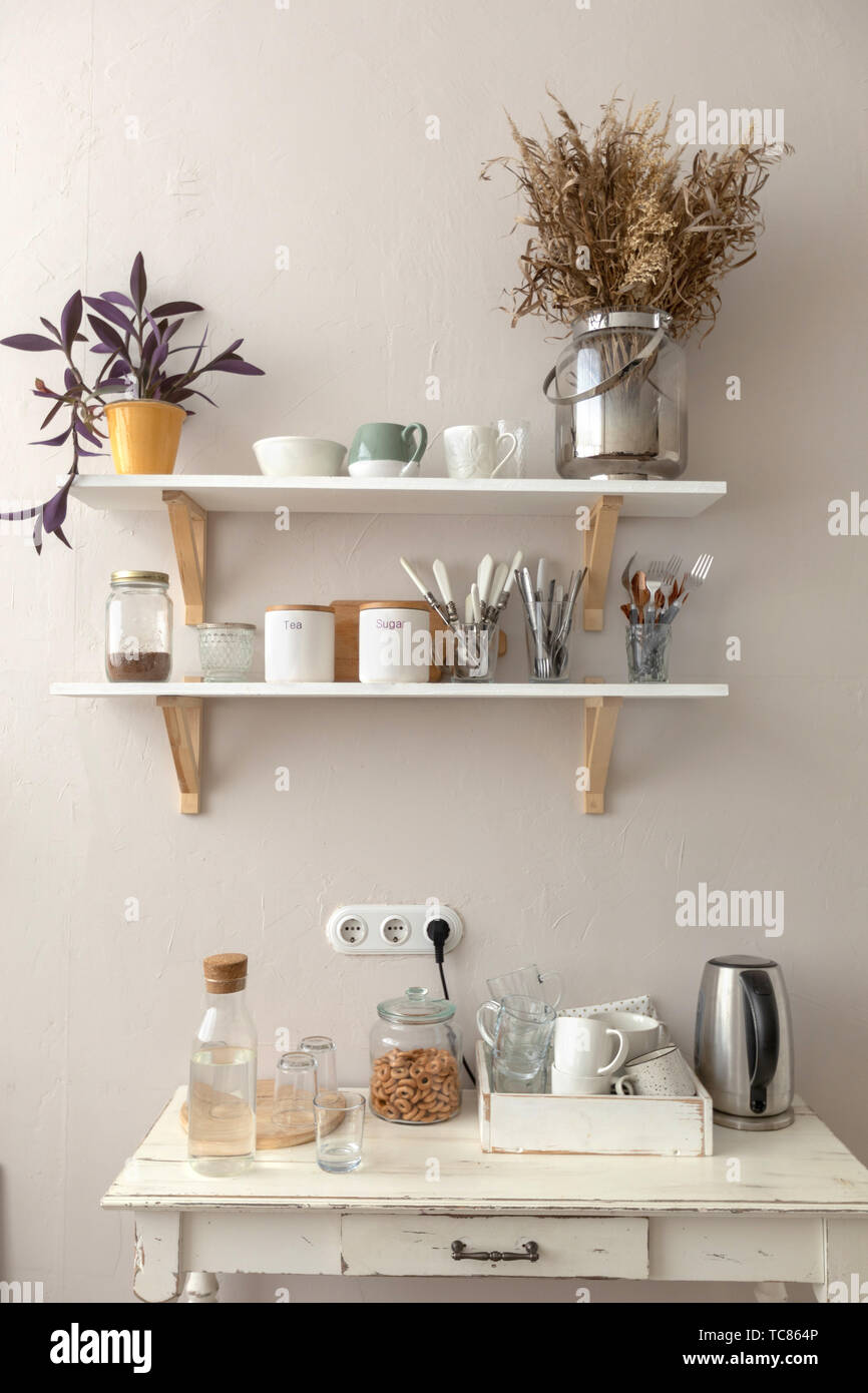 Pots with various houseplants and assorted dishware Stock Photo