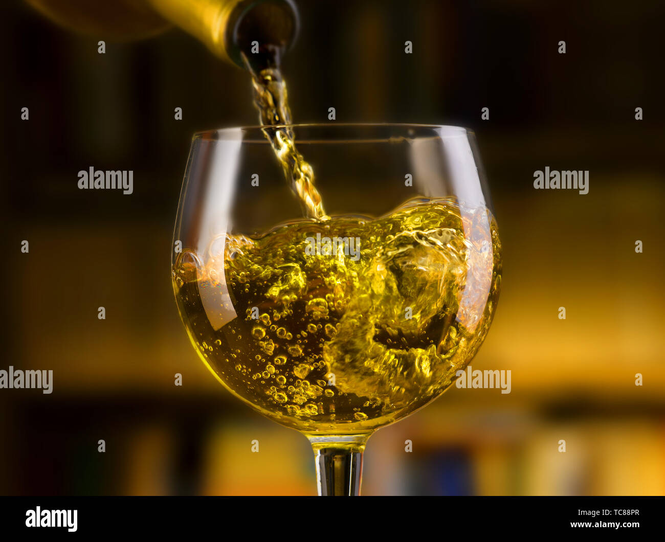 white wine poured in all its forms, library background Stock Photo