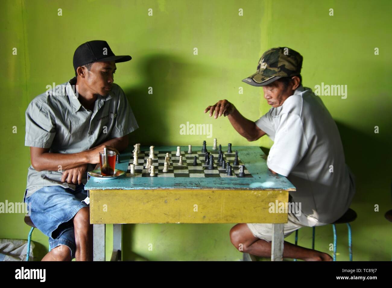 brown chess board with figures on a wooden table in a cafe, playing chess  Stock Photo - Alamy
