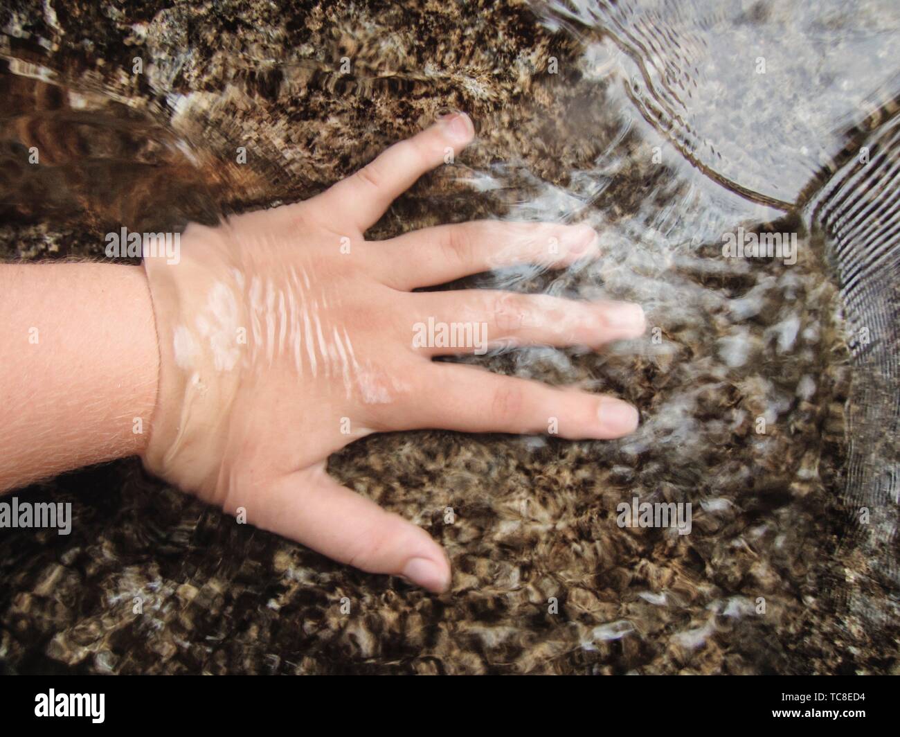 Child water hand hi-res stock photography and images - Alamy