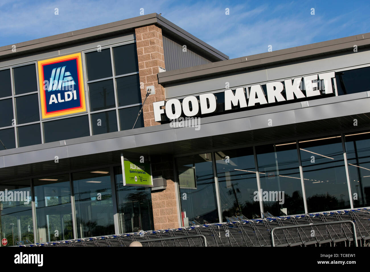 A logo sign outside of a Aldi retail grocery store location in