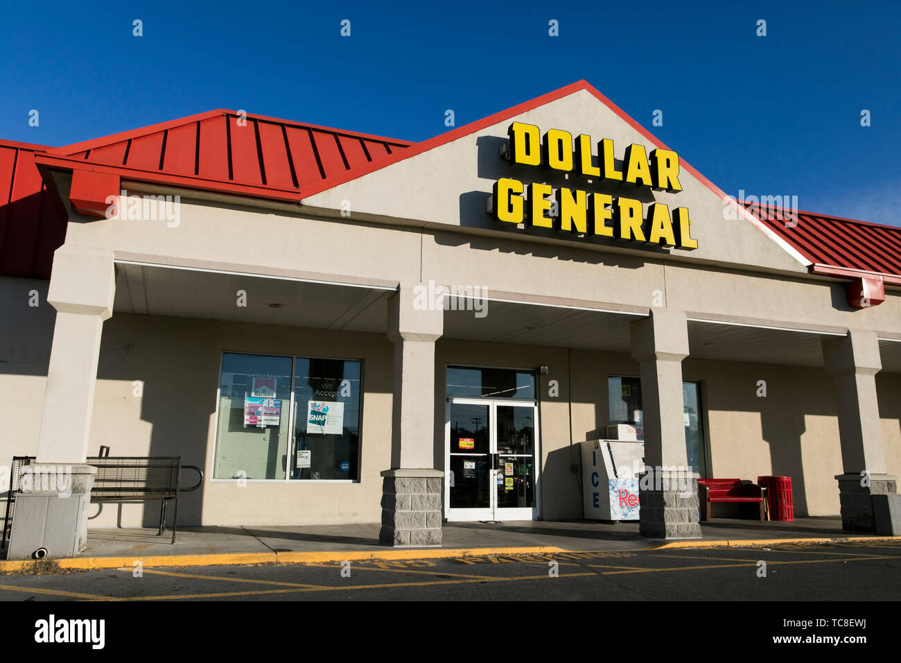A logo sign outside of a Dollar General retail store location in