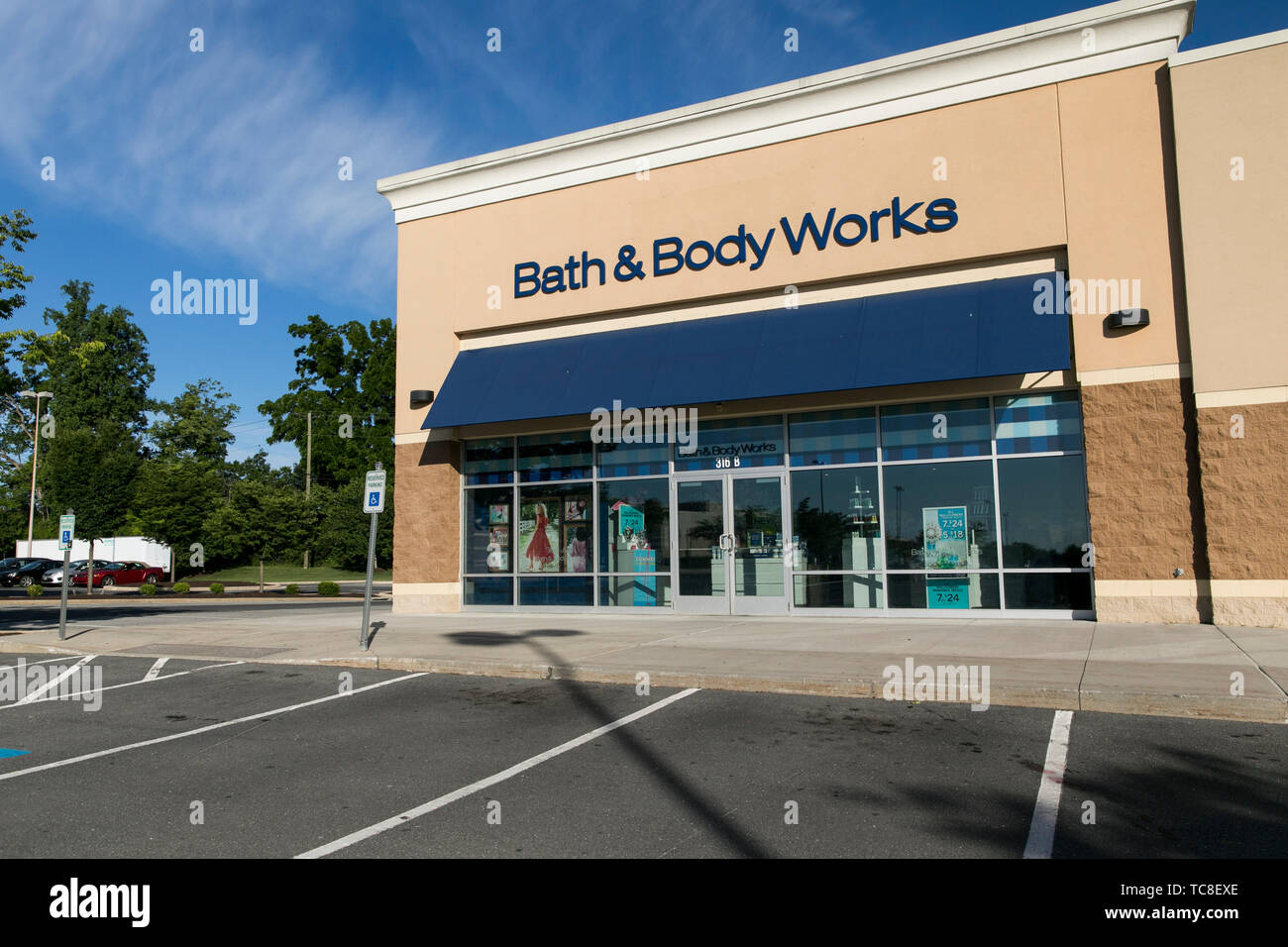 A logo sign outside of a Bath & Body Works retail store location in