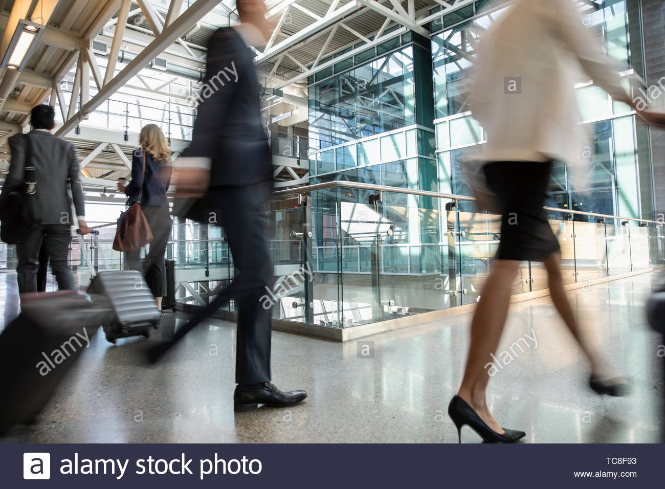 Business people with suitcases on the move in airport Stock Photo