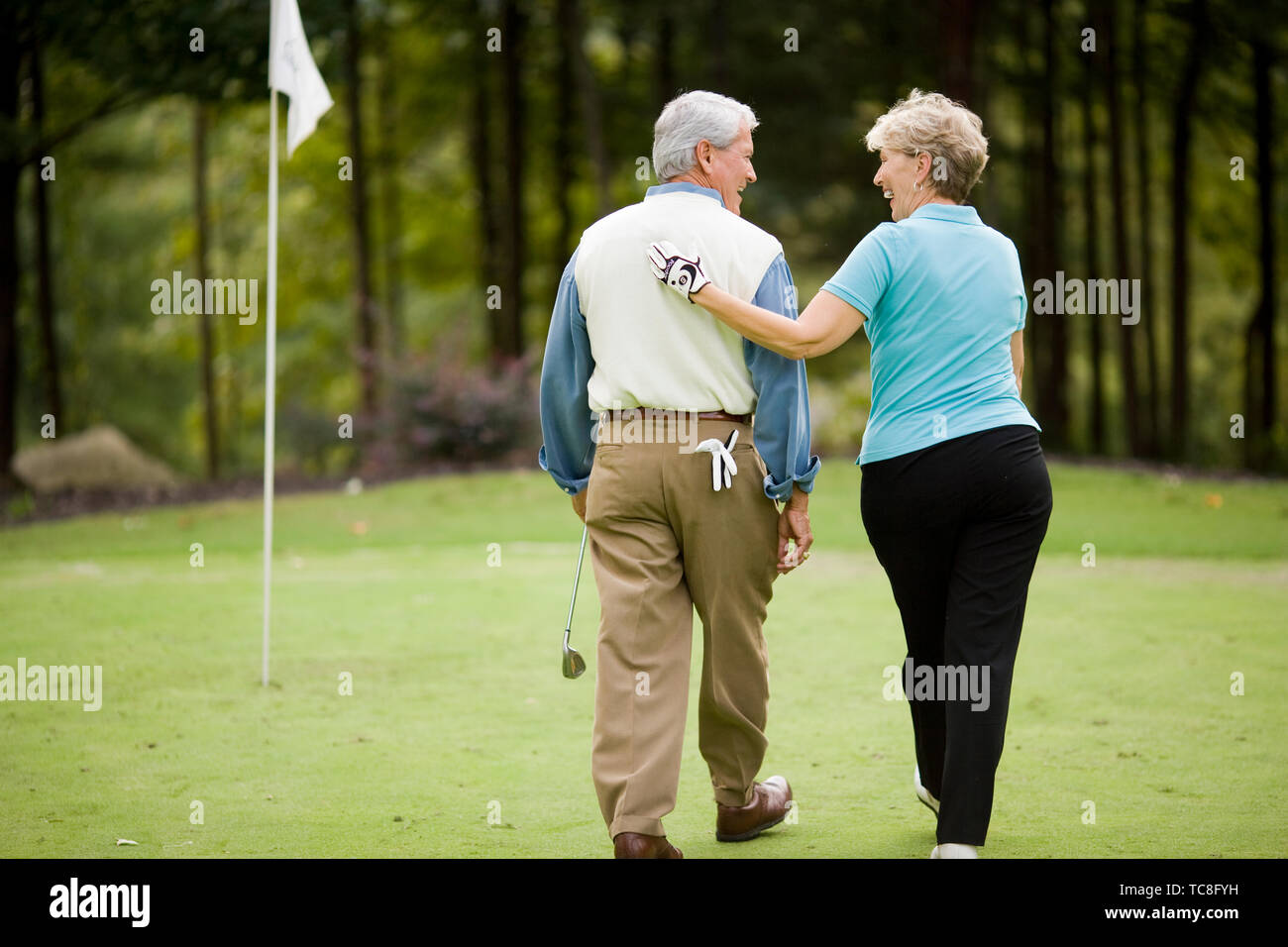 Older couple sharing a laugh on a golf course Stock Photo