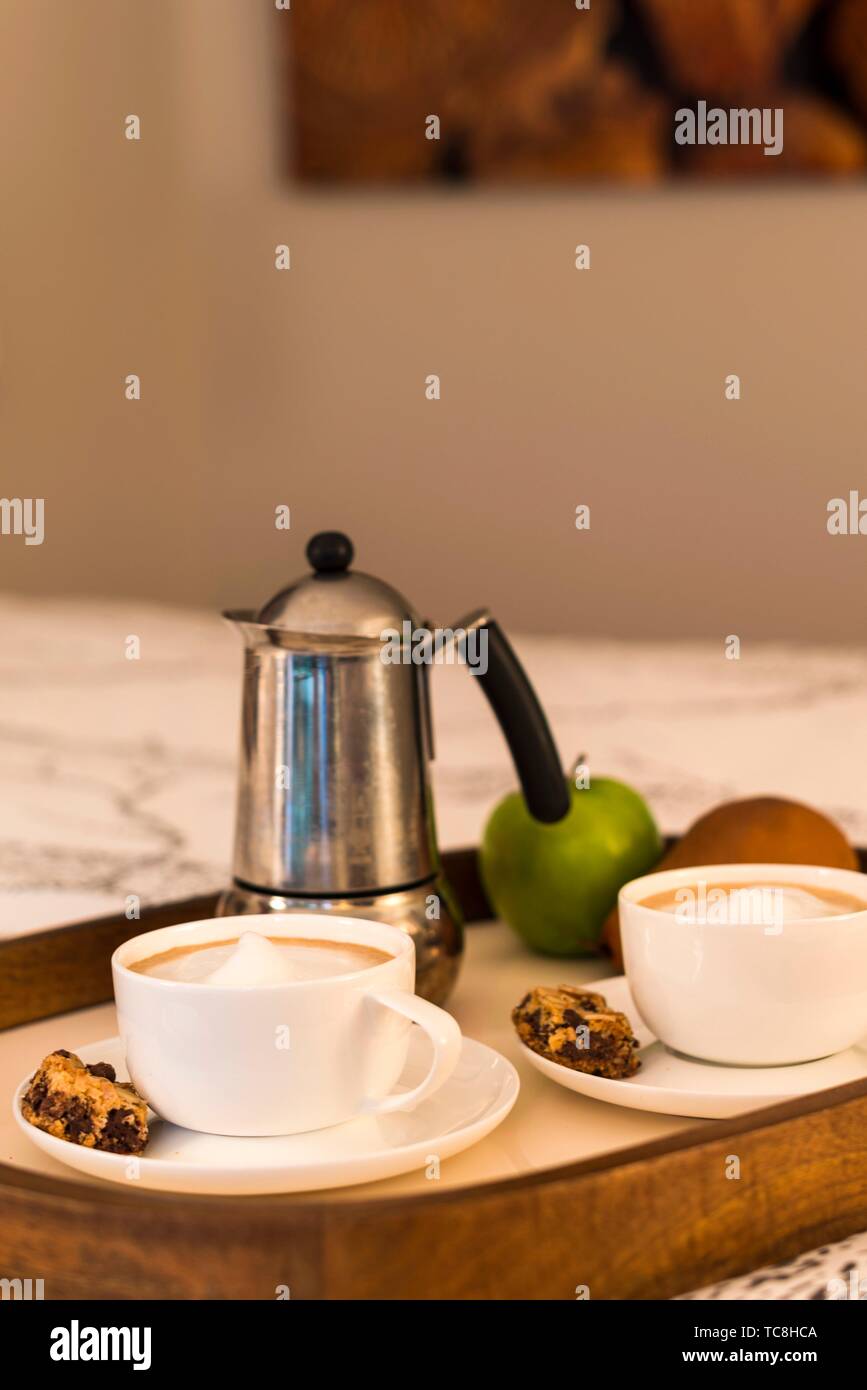 Coffee pot and cups in a bedroom in an apartment in Vancouver, BC