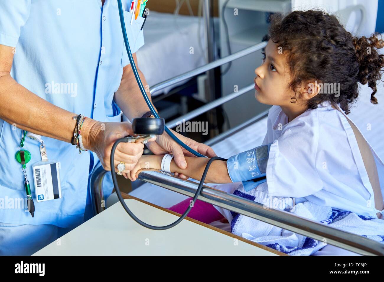 Nurse taking blood pressure to girl, Plant for hospitalization of children, Pediatrics, Medical care, Hospital Donostia, San Sebastian, Gipuzkoa, Stock Photo
