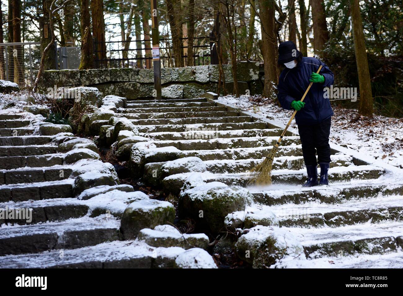 Japanese woman sweeping at Nikko National Park, Japan, Asia. Stock Photo