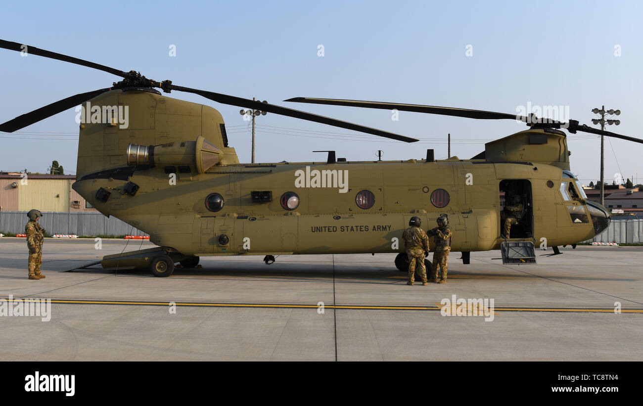 U.S. soldiers assigned to Bravo Company, 3rd General Support Aviation Battalion, conduct pre-flight inspections on a CH-47 Chinook helicopter at Osan Air Base, Republic of Korea, June 2, 2019. The soldiers supported a visit from acting U.S. Secretary of Defense Patrick Shanahan. Shanahan came to the ROK as part of his trip to the Indo-Pacific where he visited four countries and met with 19 defense ministers and heads of state over the course of eight days. (U.S. Air Force photo by Staff Sgt. Sergio A. Gamboa) Stock Photo