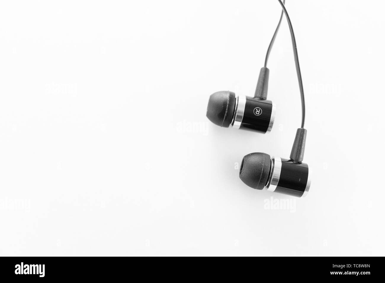 Black wired earbuds Stock Photo