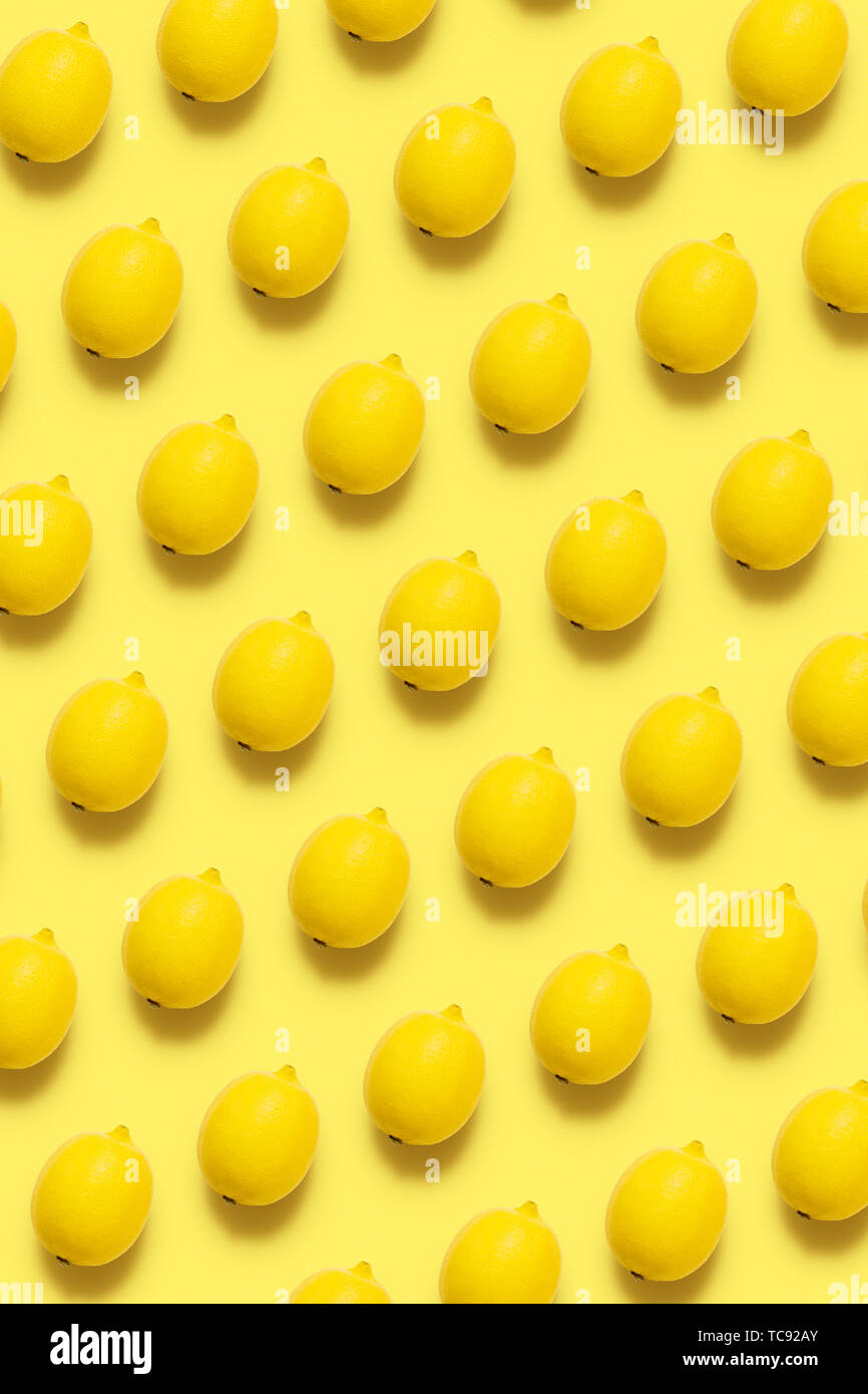 Lemon pattern on pastel yellow background. Minimal summer concept Flat lay  Vertical Stock Photo - Alamy
