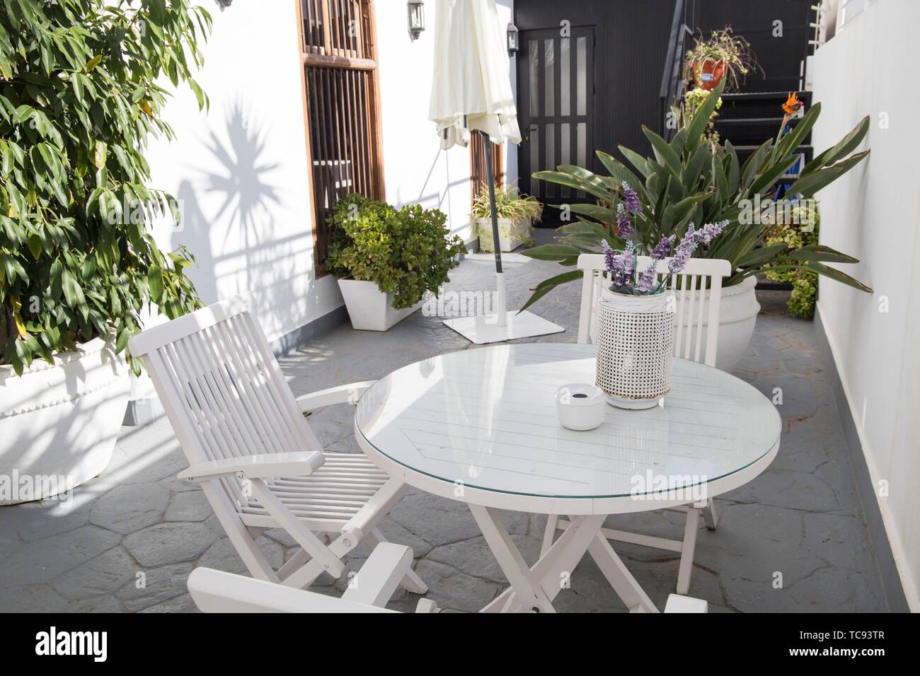 Patio With Plants And Furniture In White Spain Stock Photo