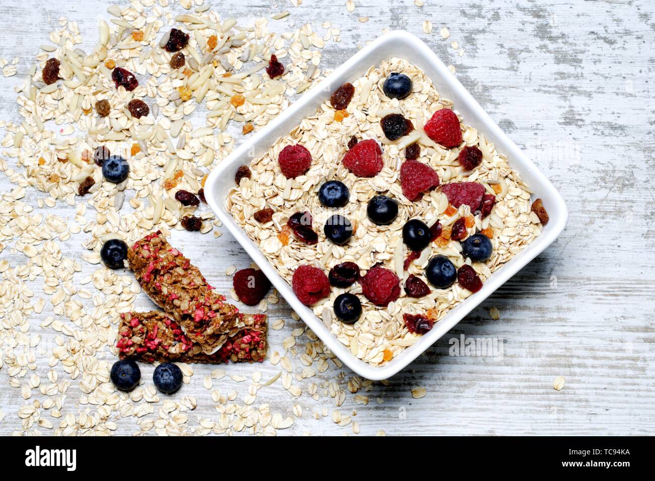 Oat grains with blueberries raspberries and cereal bars Stock Photo