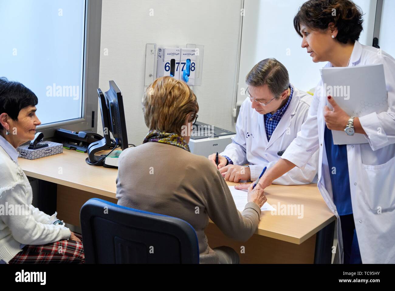 Doctors with patient in medical consultation, Oncology, Hospital